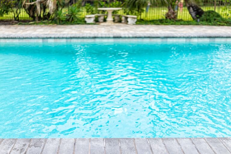 Generic blue saltwater pool in tropical setting with closeup of water